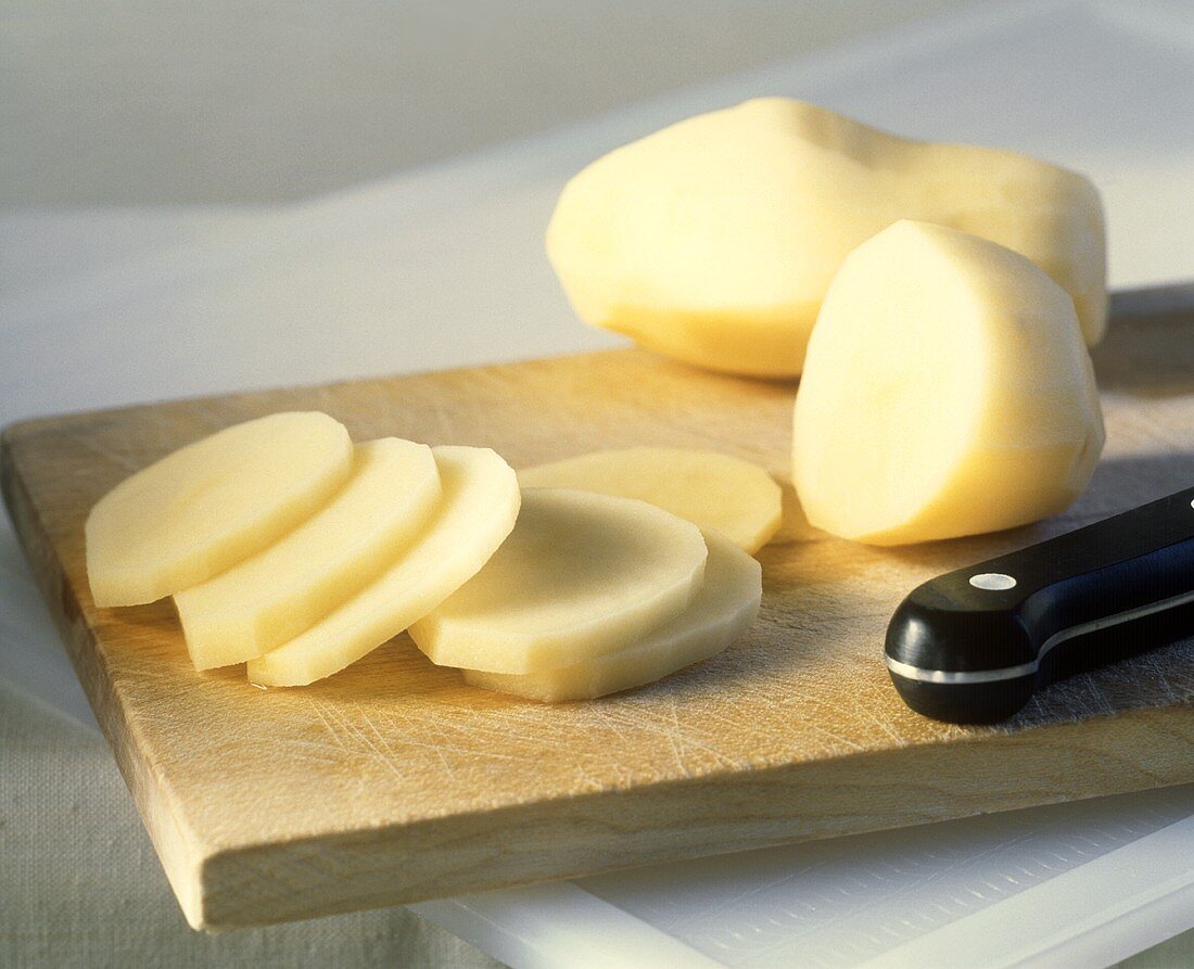 Raw potatoes, peeled and some chopped