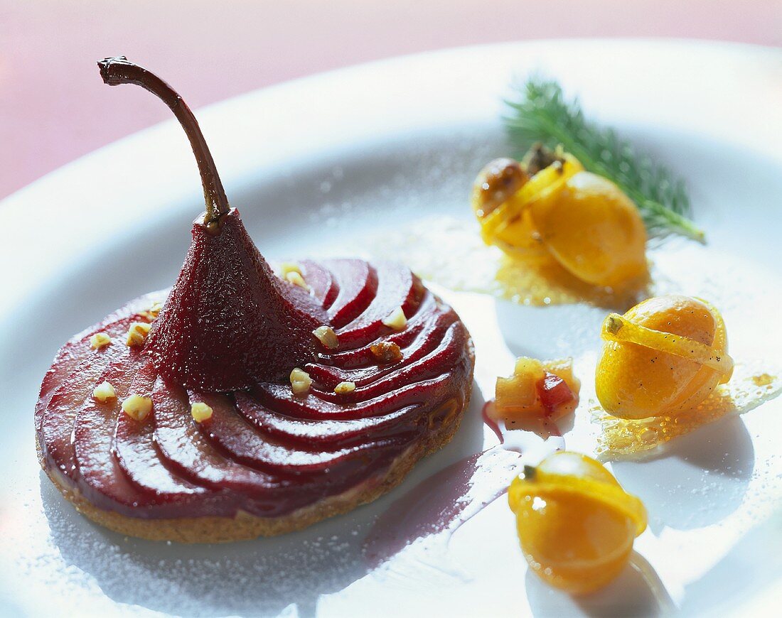 Tart with red wine pears and candied kumquats