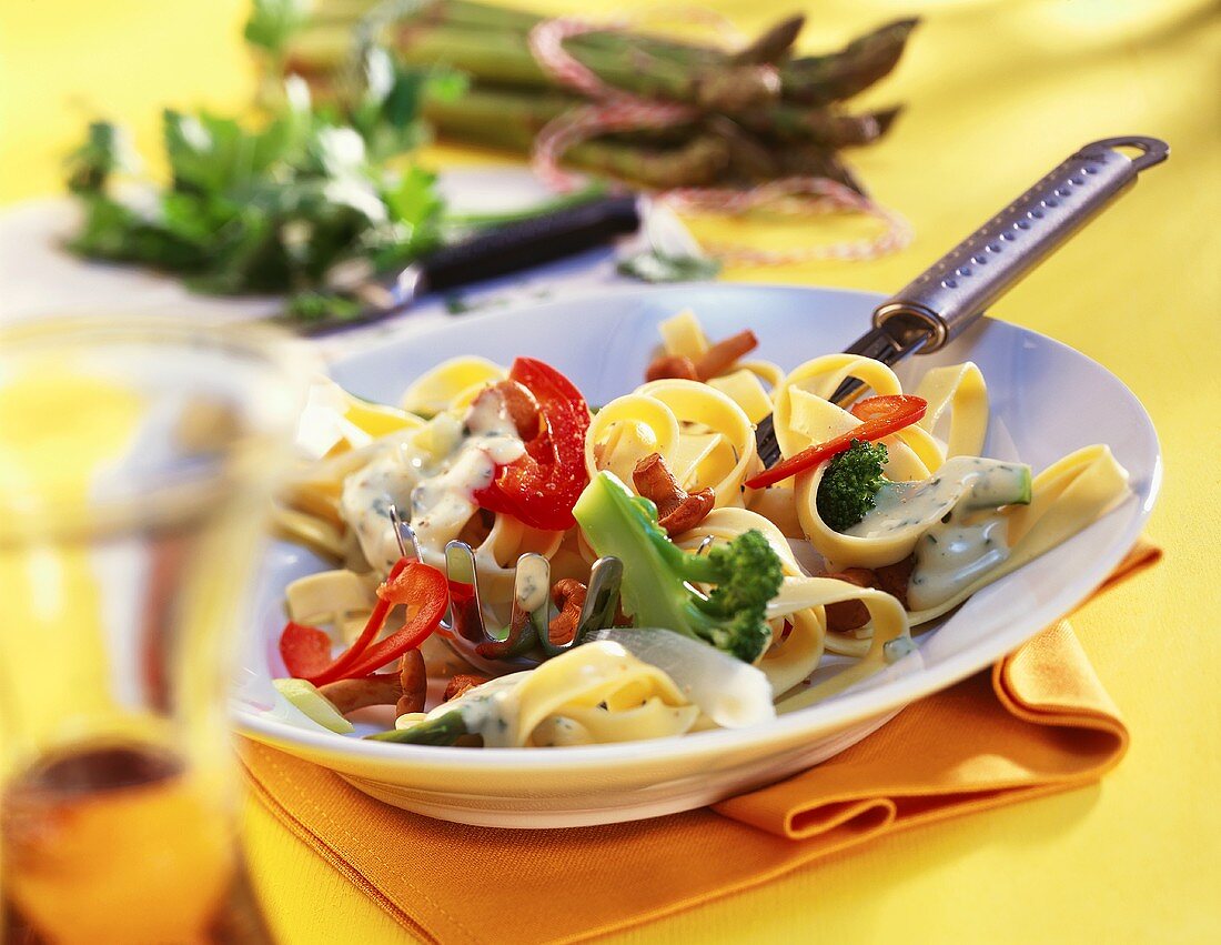 Tagliatelle with chanterelles, vegetables and cream sauce