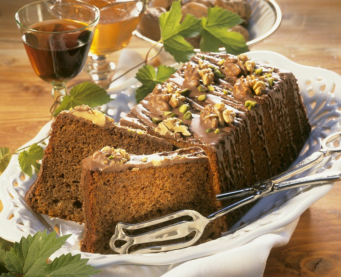 Walnut cake with chocolate icing and chopped pistachios