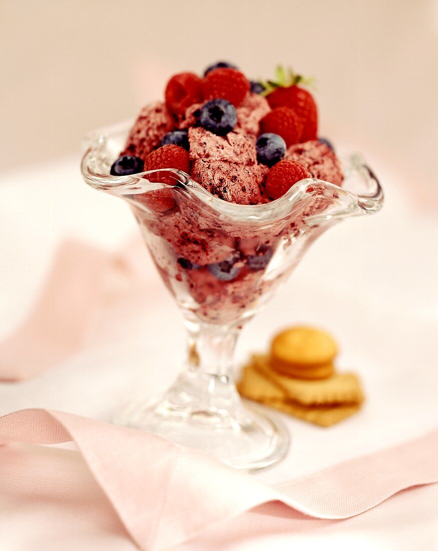 Berry ice cream with fresh summer berries in a glass