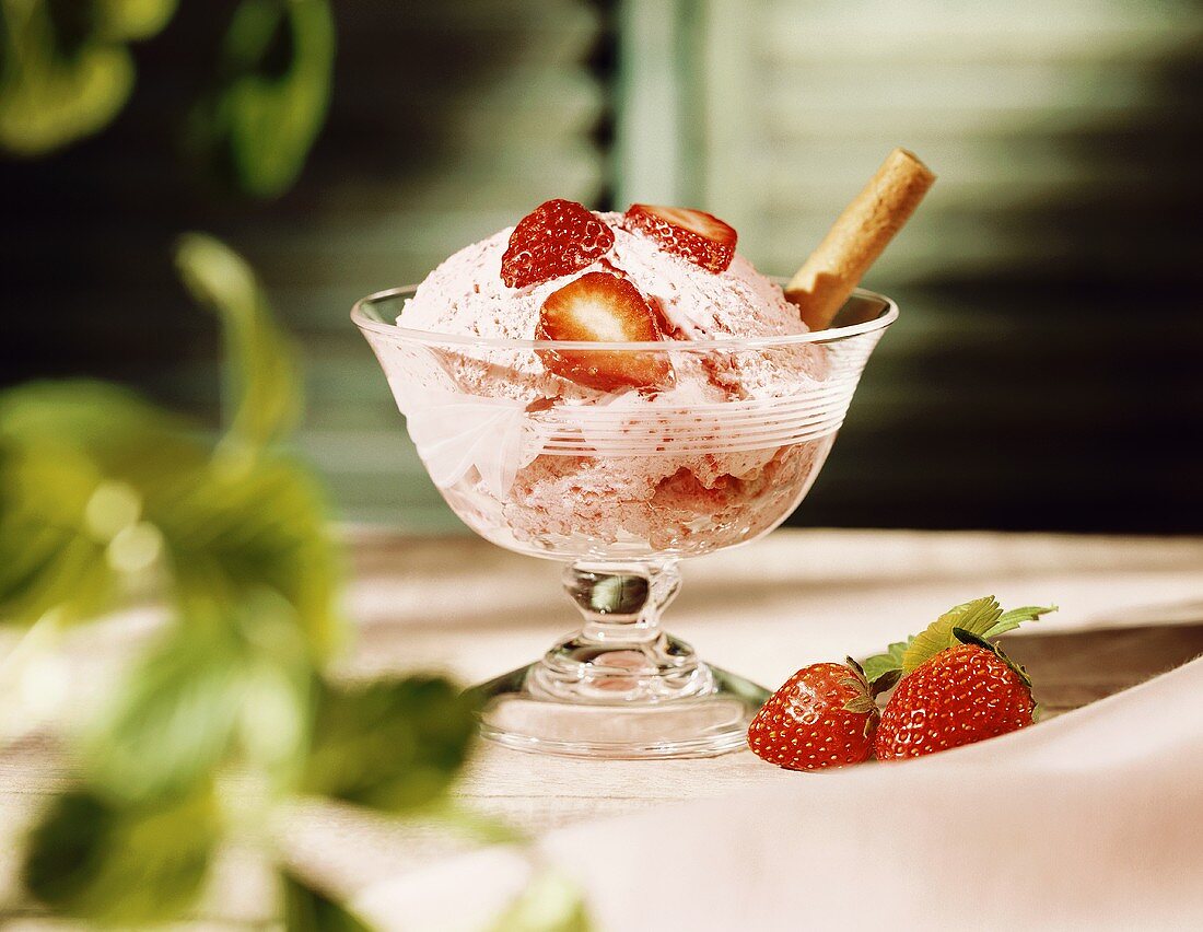 Strawberry ice cream with fresh strawberries and wafer