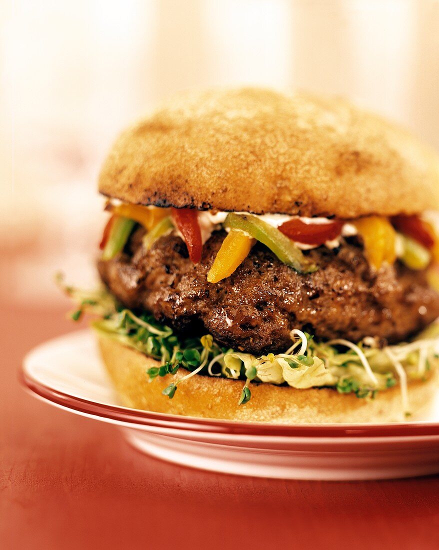 Hamburger with grilled peppers and sprouts