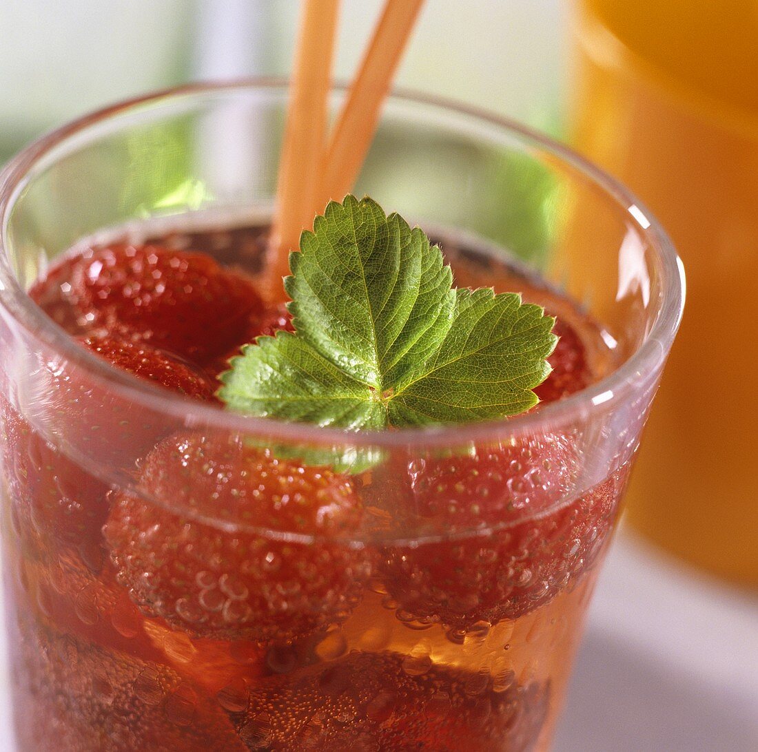 Strawberry punch with strawberry leaf in glass