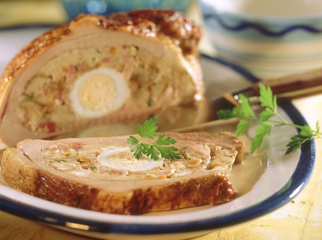 Veal breast with bread roll stuffing and egg, carved