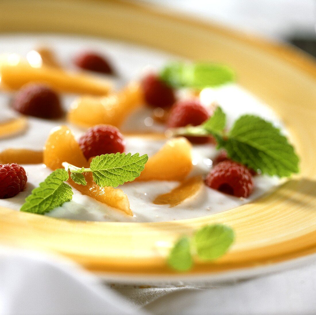 Cold kefir soup with apricots, raspberries and lemon balm