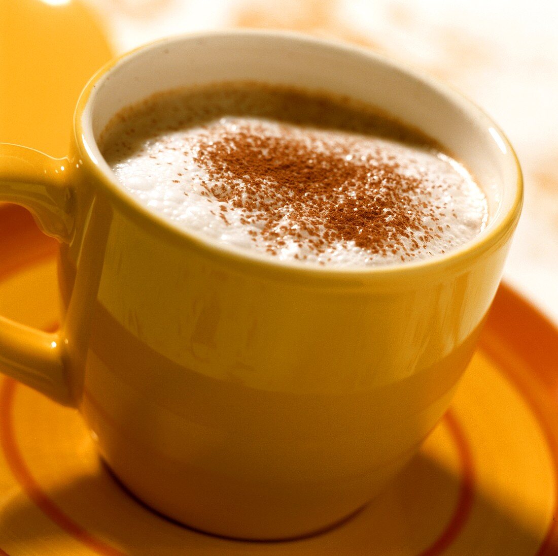 Children's cappuccino in a yellow cup