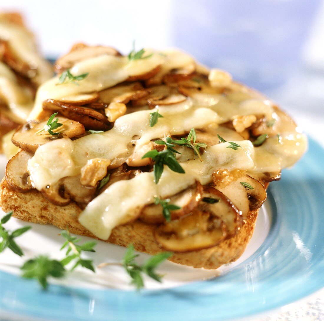 Mushrooms on toast with walnuts, cheese & thyme leaves
