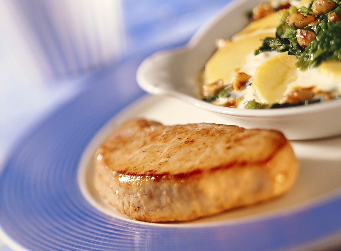 Veal steak with spinach and potato gratin