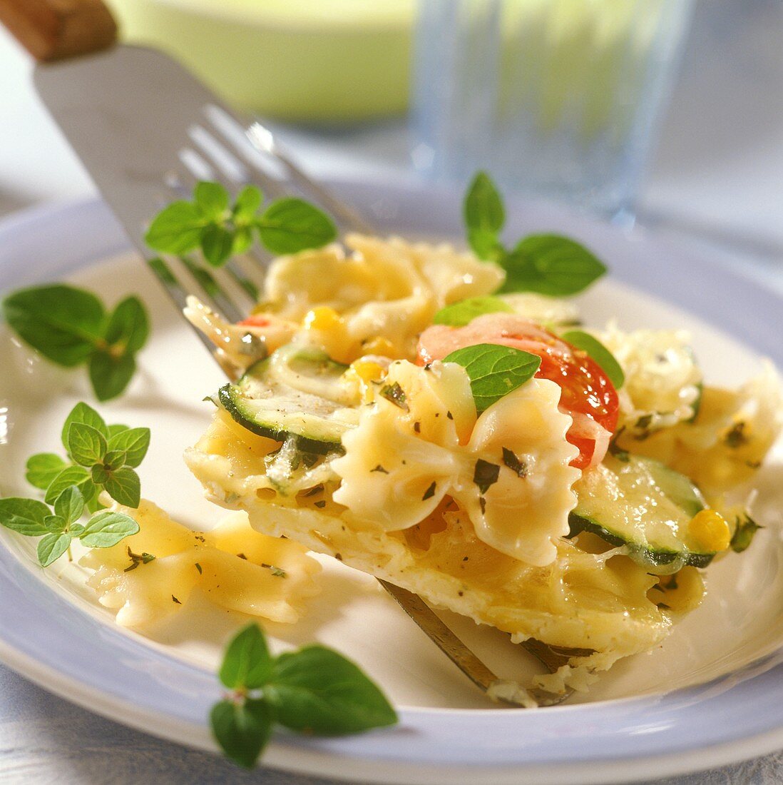 Farfalle with courgettes and tomatoes on spatula