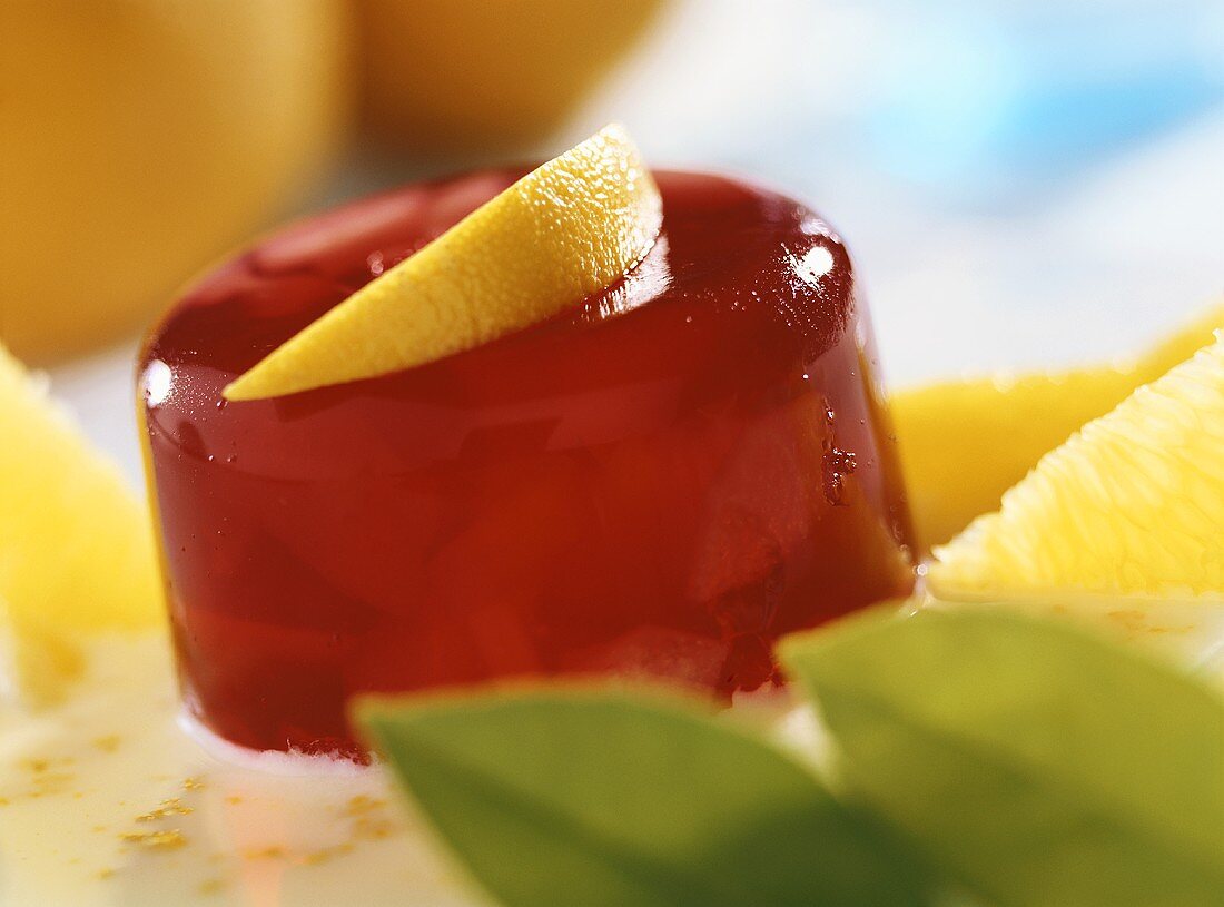 Pear jelly with orange sauce and lemon wedge