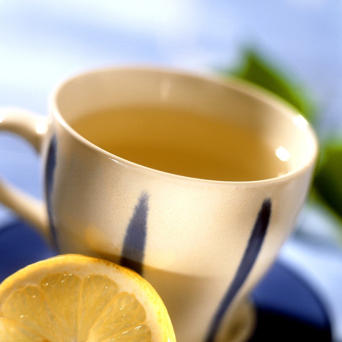 Herb tea with lemon in blue and white cup