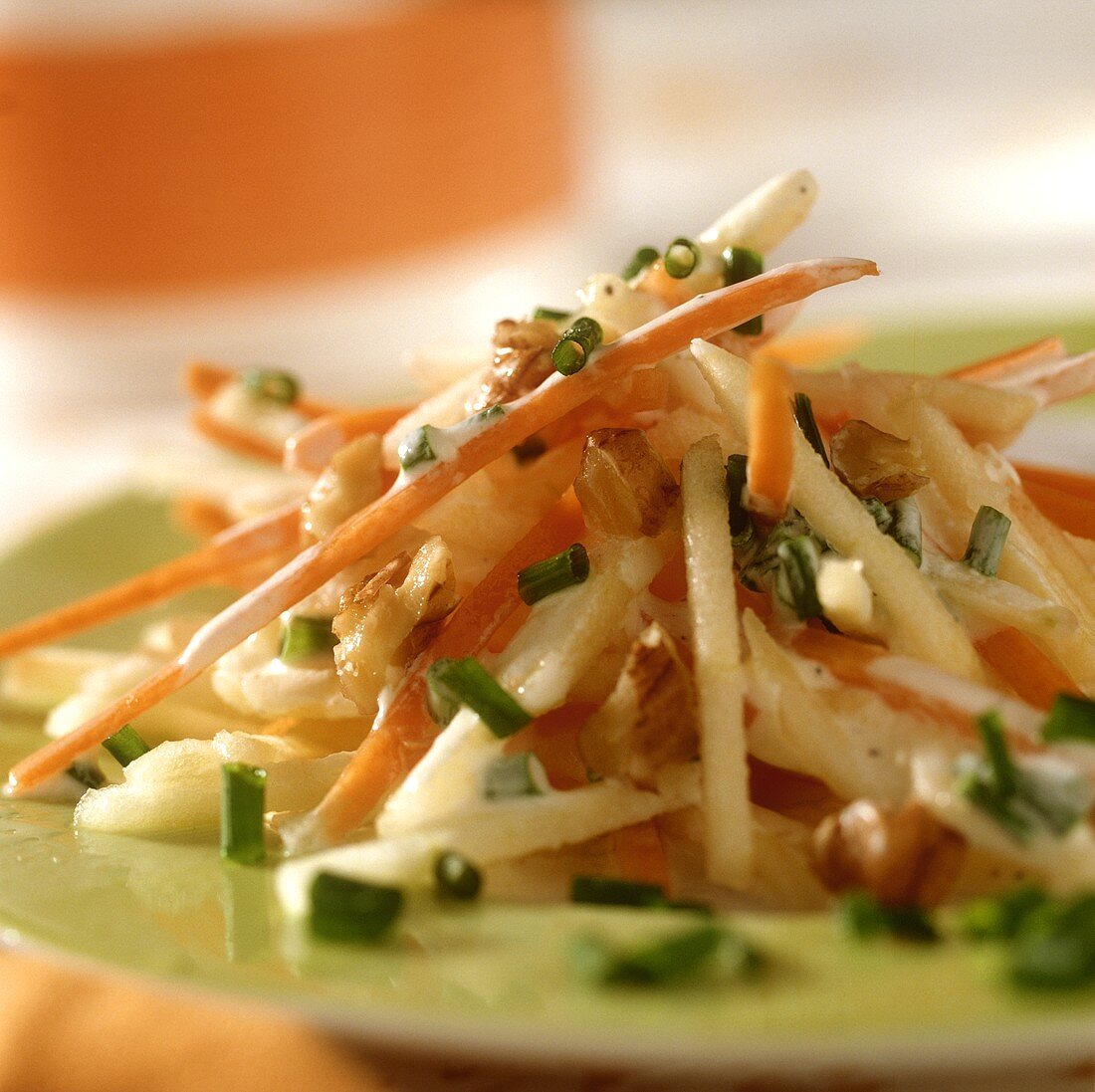 Carrot and apple salad with nuts and chives