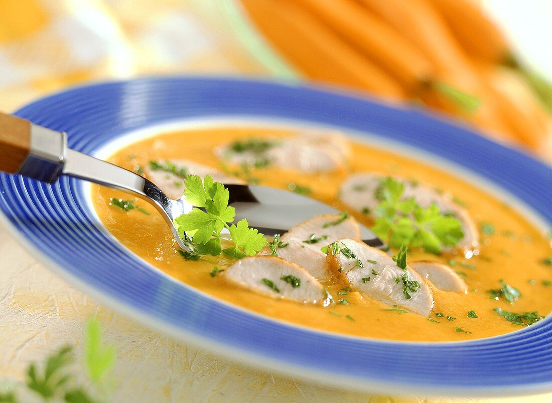 Cream of carrot soup with turkey breast and parsley