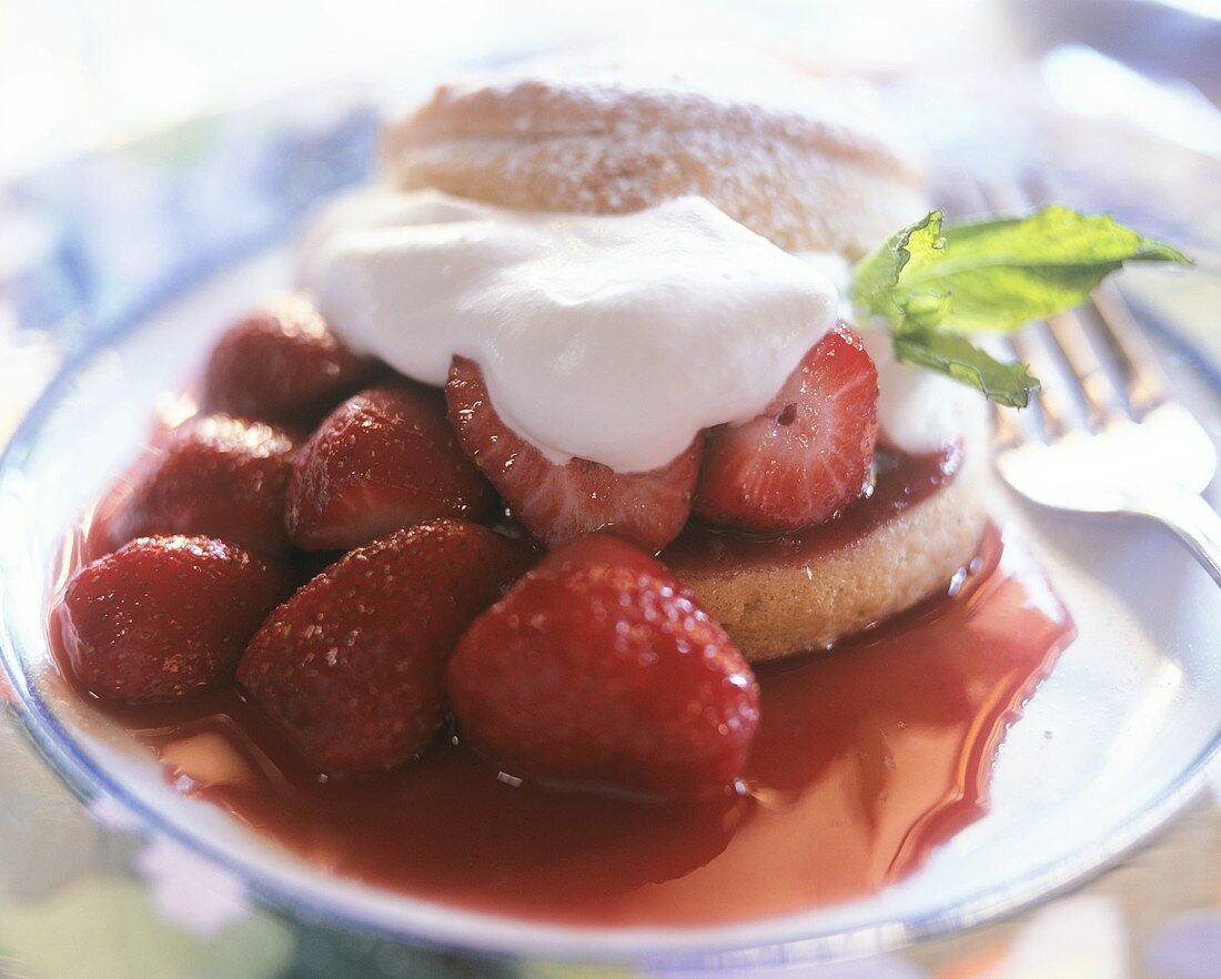 Strawberry tartlets with cream on plate
