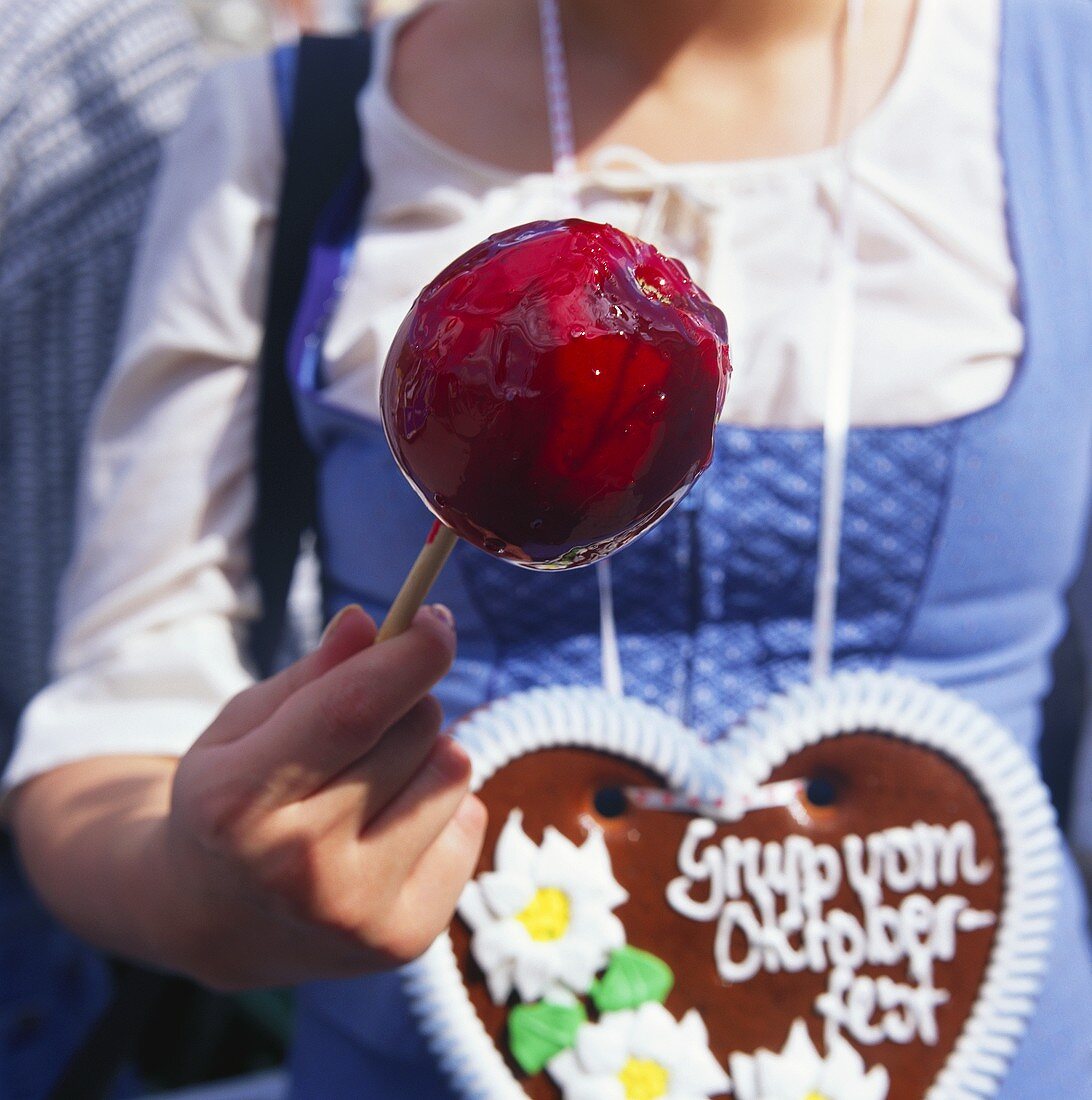 Woman with love-apple & gingerbread heart at Oktoberfest