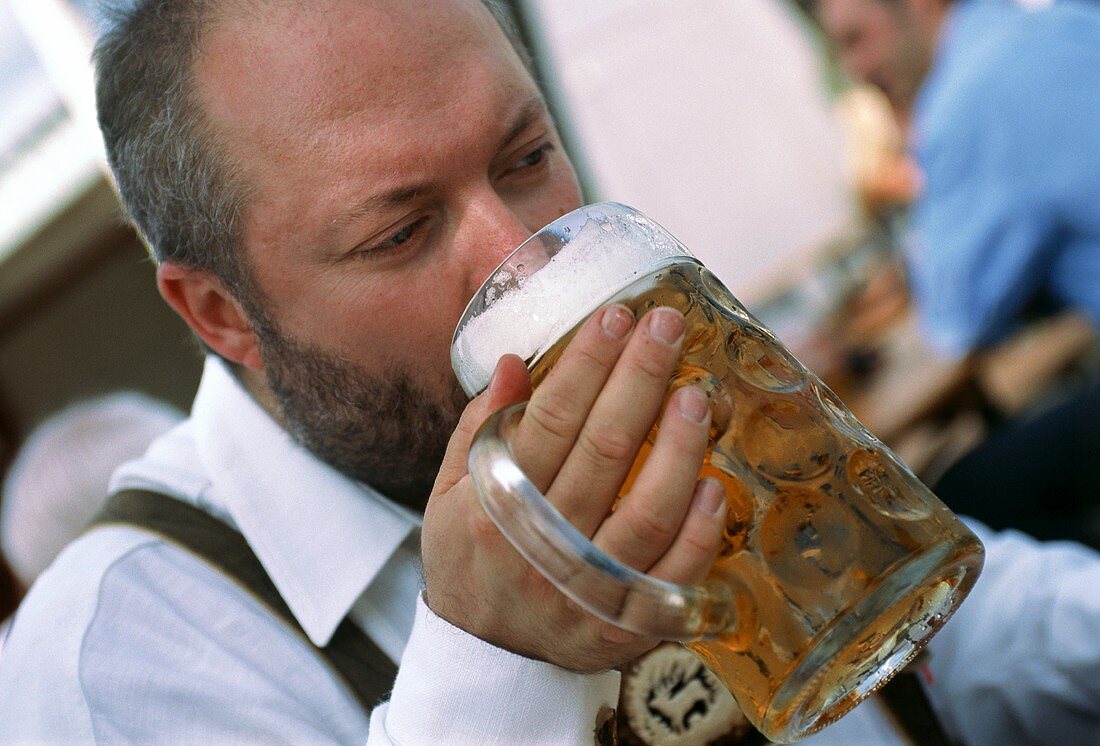 Man drinking a litre of beer at Oktoberfest