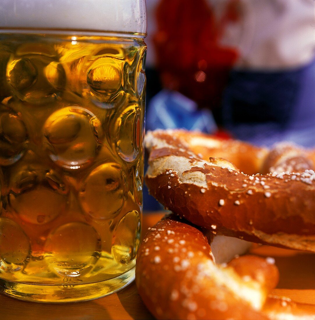 Tankard and two pretzels on table at Oktoberfest
