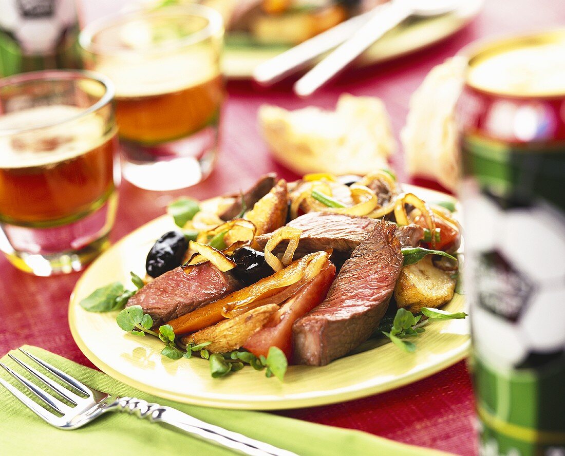 Slices of beef fillet with vegetables on plate