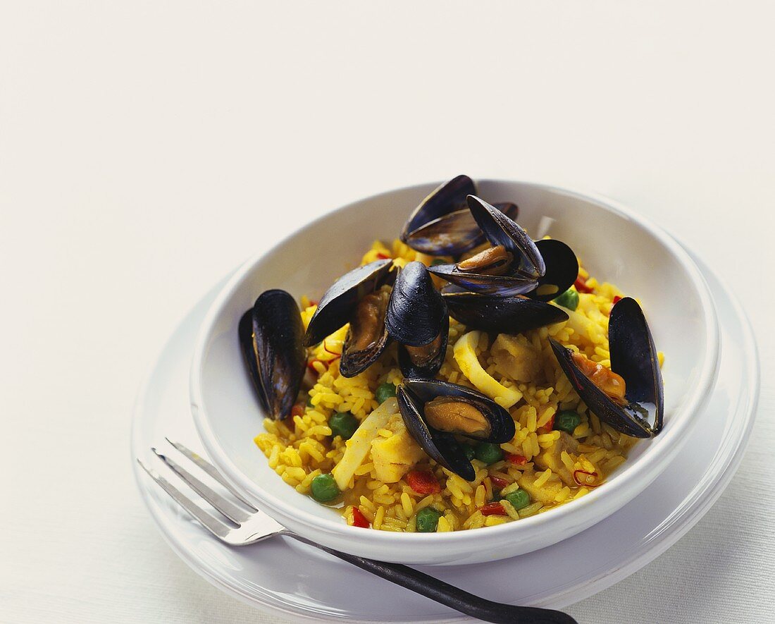 Paella with mussels in deep plate