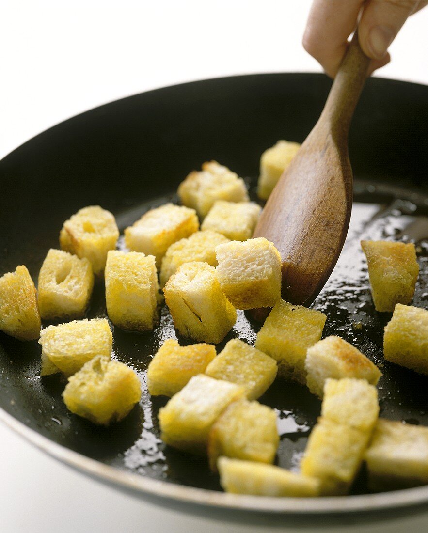 Frying croutons in a pan