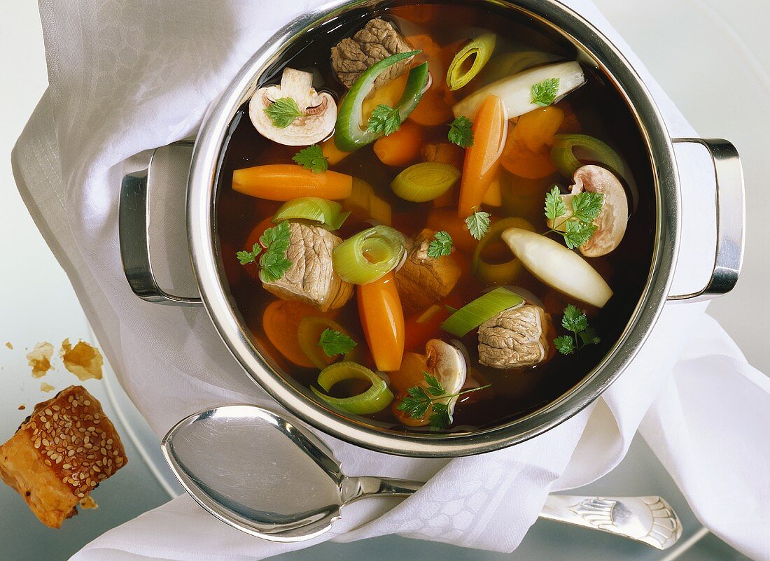 Vegetable soup with beef in soup pot
