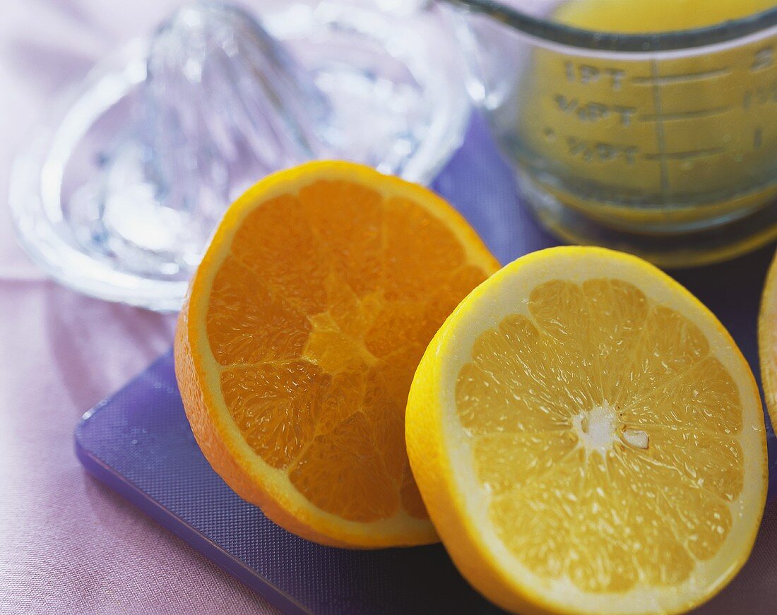 Orange & grapefruit halves, lemon squeezer & measuring jug