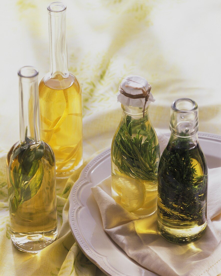 Three bottles of herb oil and a bottle of lemon oil