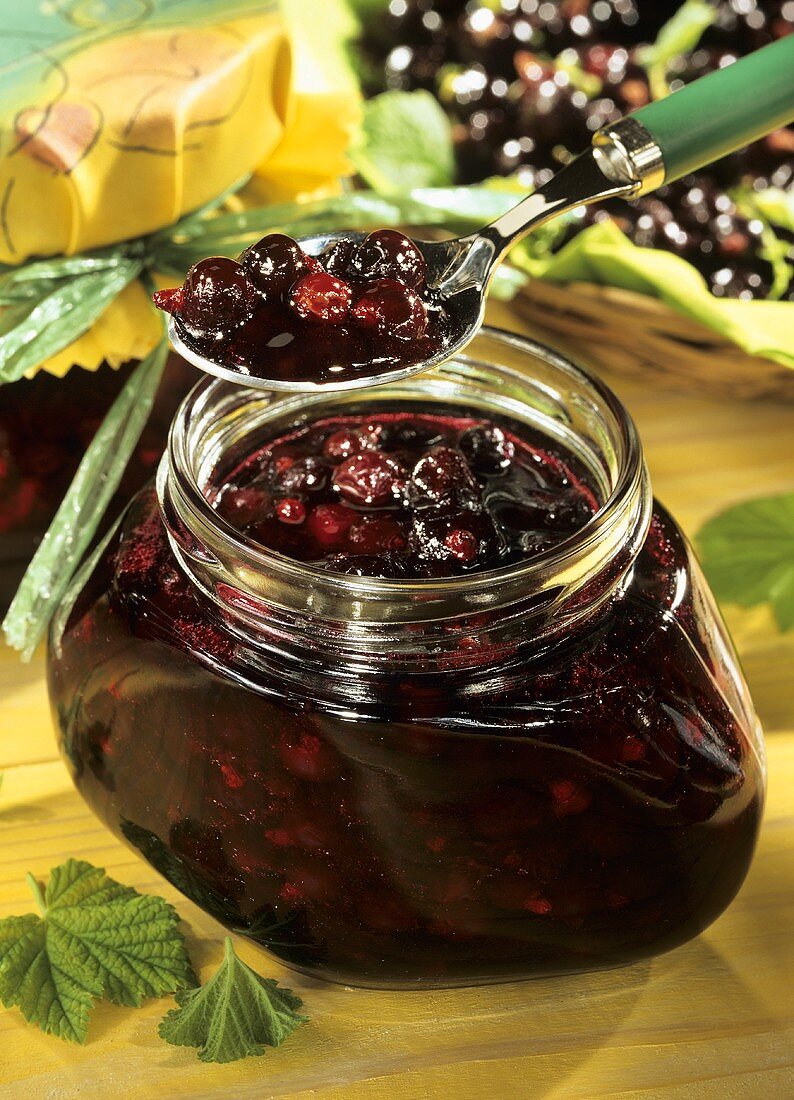 Blackcurrant jam in jar and on spoon