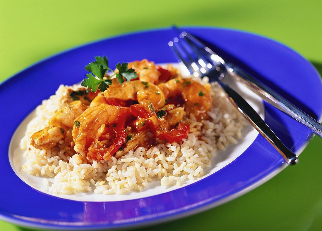 Spicy chicken breast with shrimps and peppers on rice