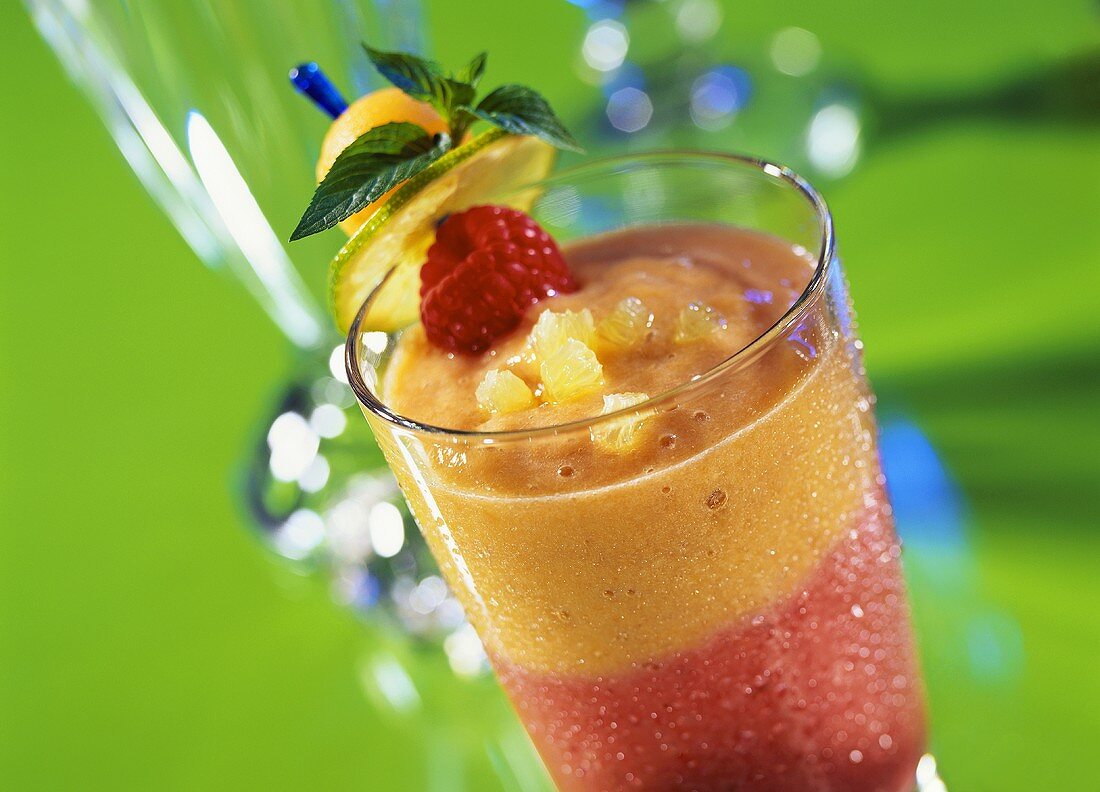 Fruity summer cocktail with pineapple & raspberries