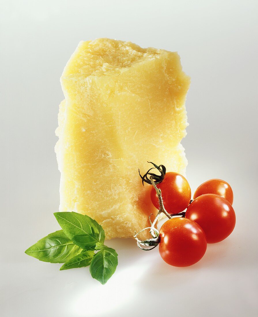 Piece of parmesan, vine tomatoes and basil