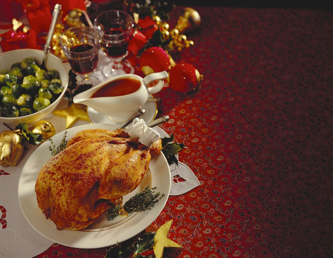 Roast Christmas turkey on plate; Brussels sprouts; gravy