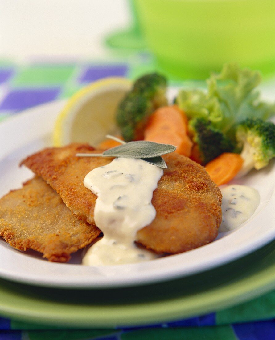 Chicken cutlet with tartar sauce and vegetables