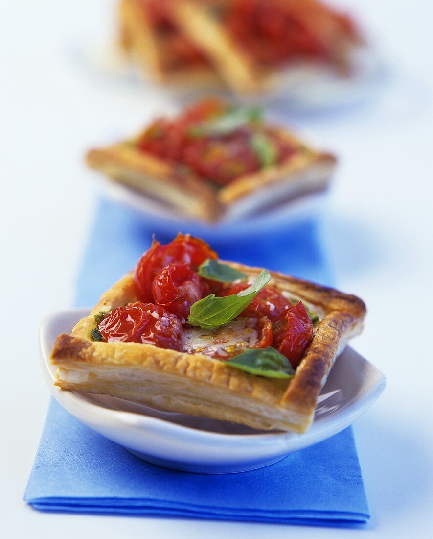 Puff pastry squares with tomatoes and fresh basil