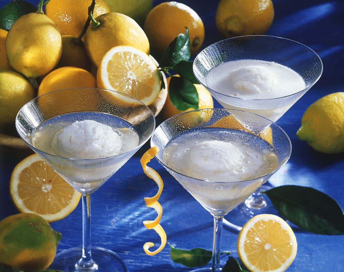 Lemon sorbet in champagne, surrounded by fresh lemons