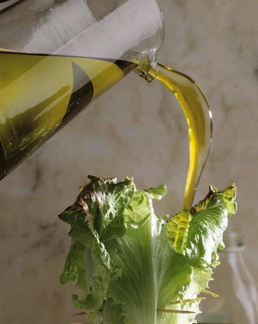 Öl über Salatblätter gießen