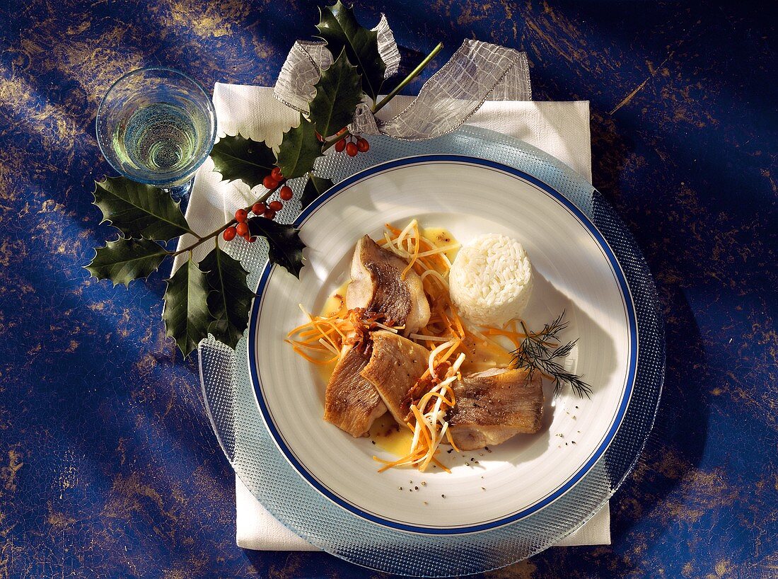 Karpfenfilets im Wurzelsud mit Reis auf Teller