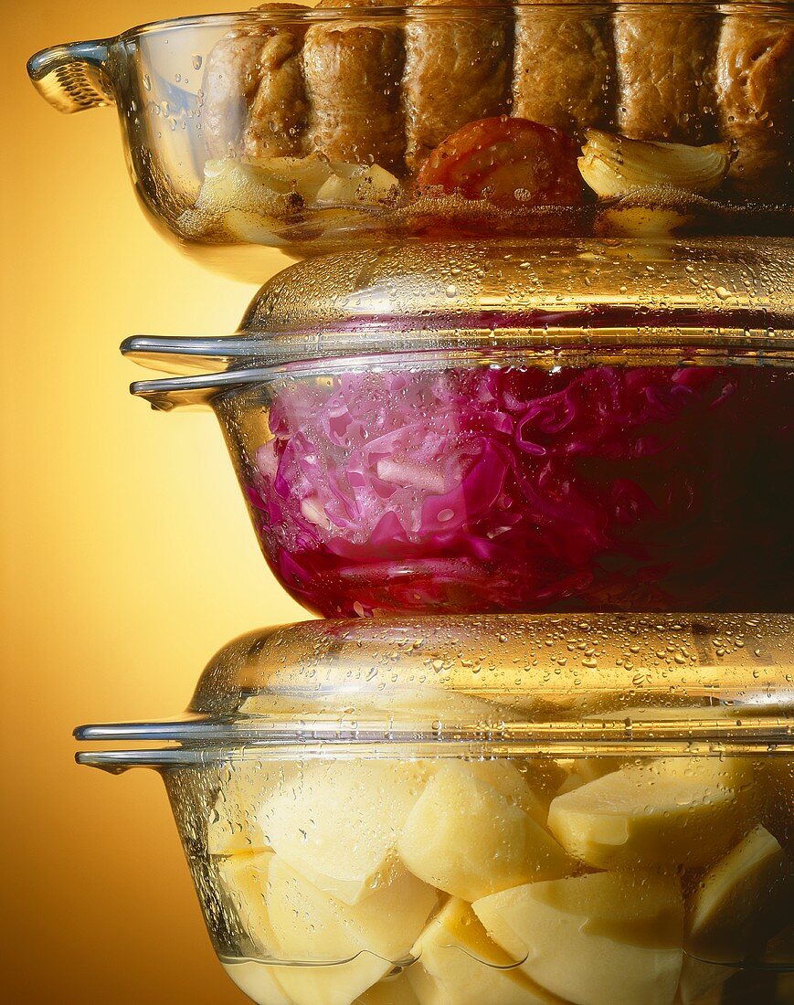 Potatoes, red cabbage & meat in glass pots 