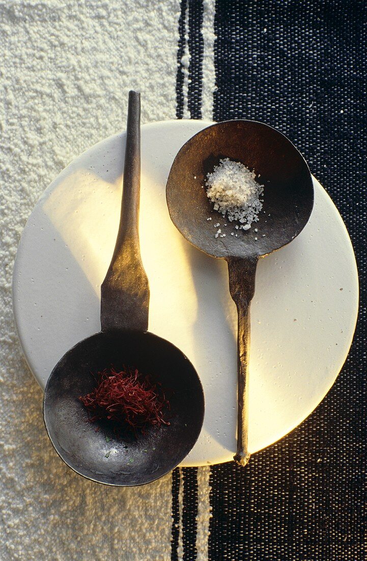 Sea salt and saffron in iron scoops