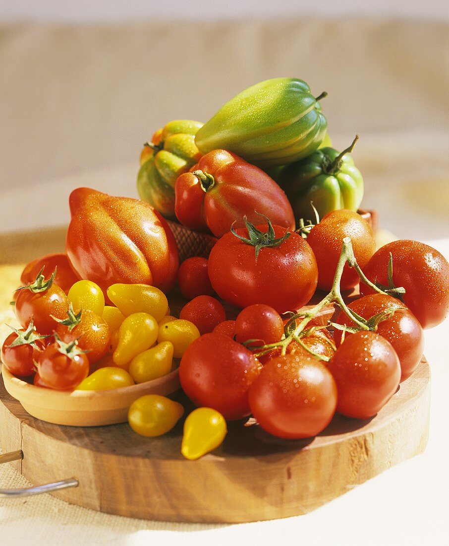 Various types of tomato on a wooden plate
