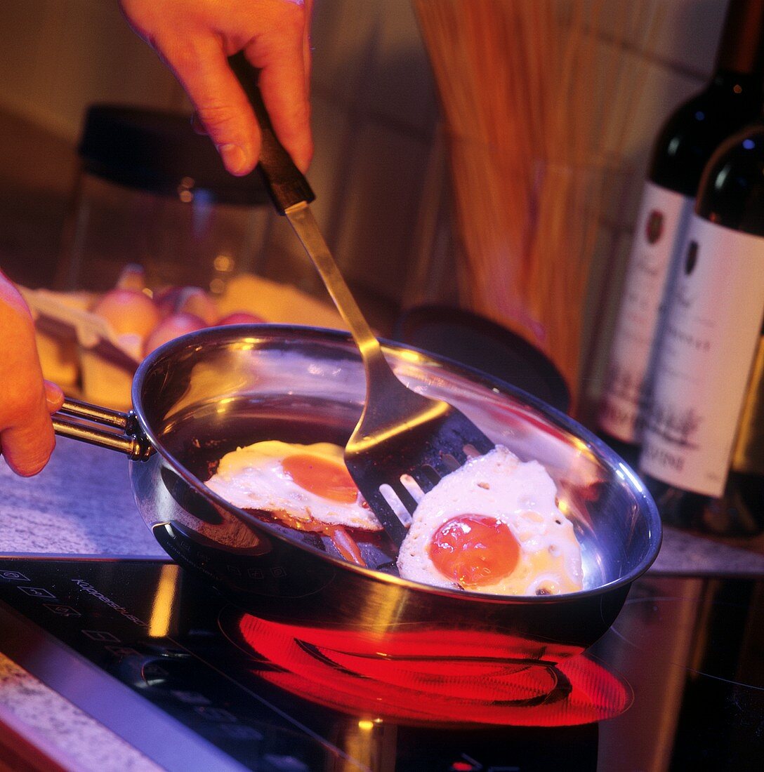 Eggs frying in a pan on a Ceran cooktop