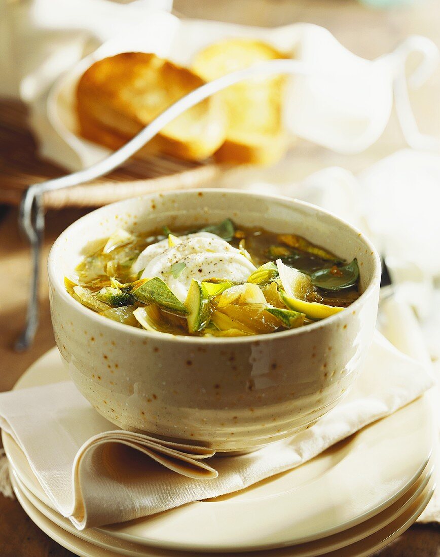 Courgette soup with courgette flowers and mozzarella