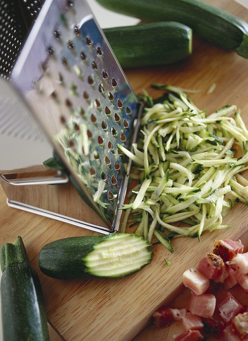 Grated courgettes on wooden chopping board