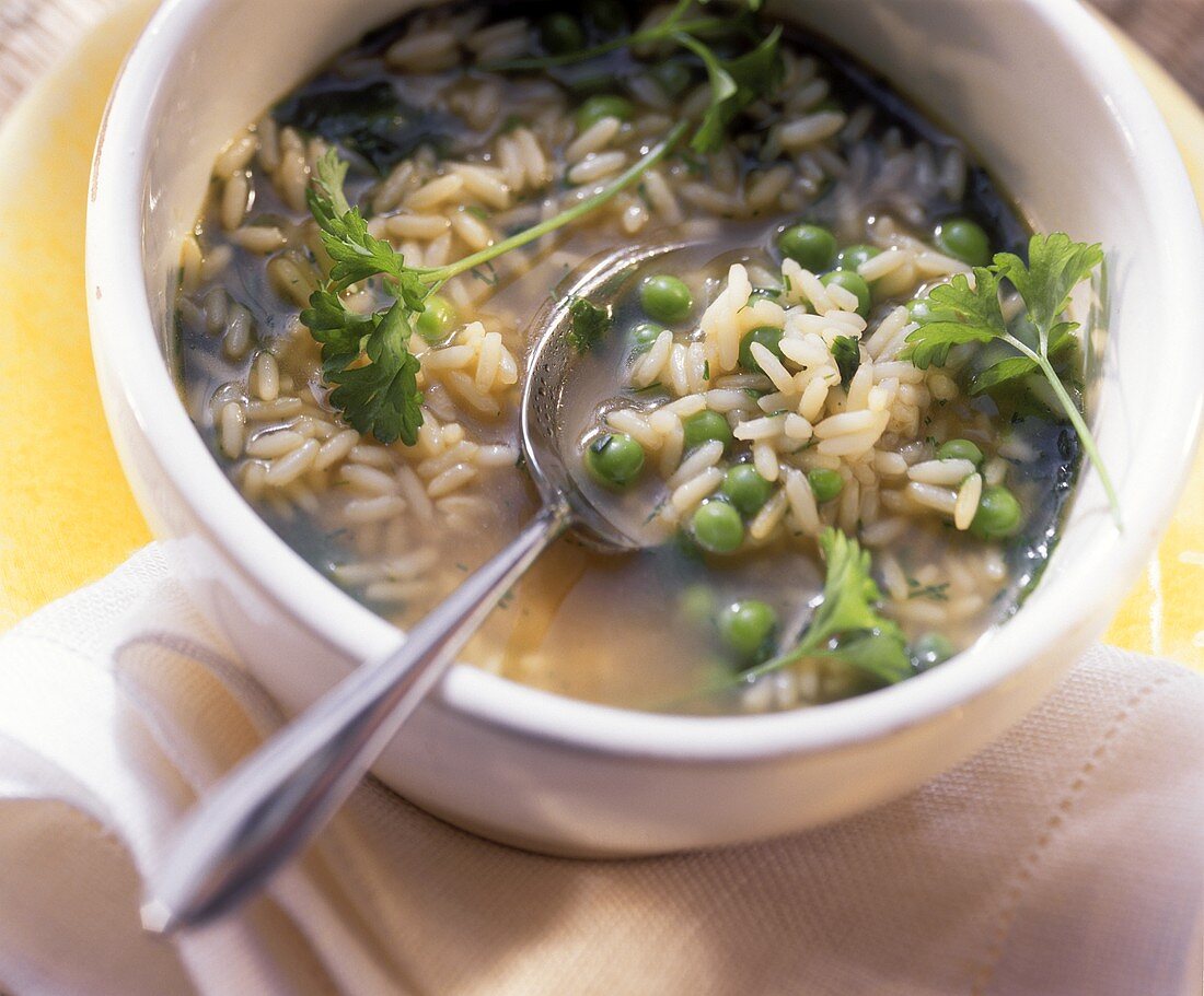 Rice soup with peas and fresh parsley
