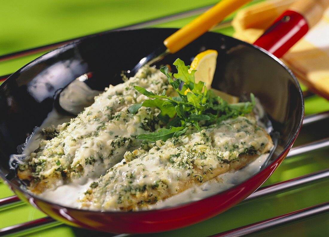 Creamy trout fillets with rocket in the pan