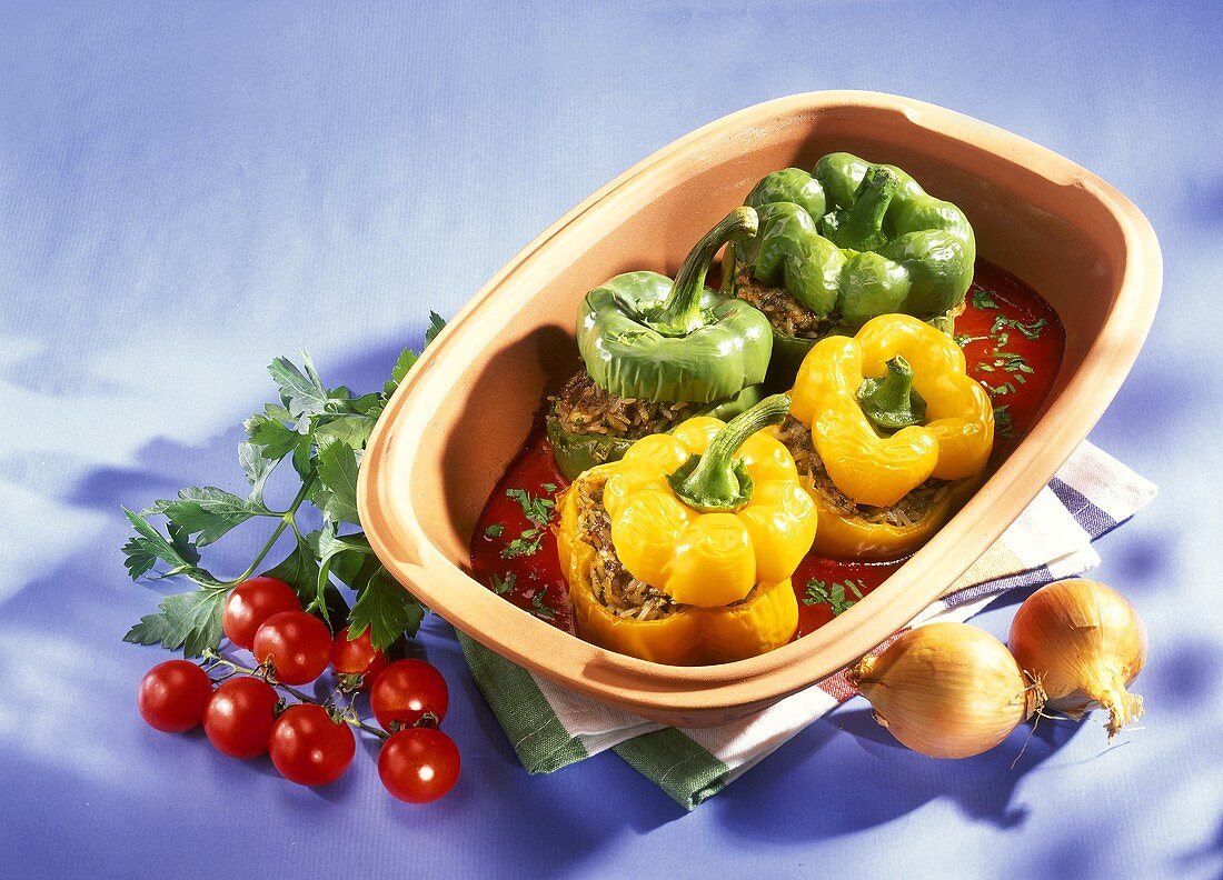 Stuffed peppers with tomato sauce in a Römertopf