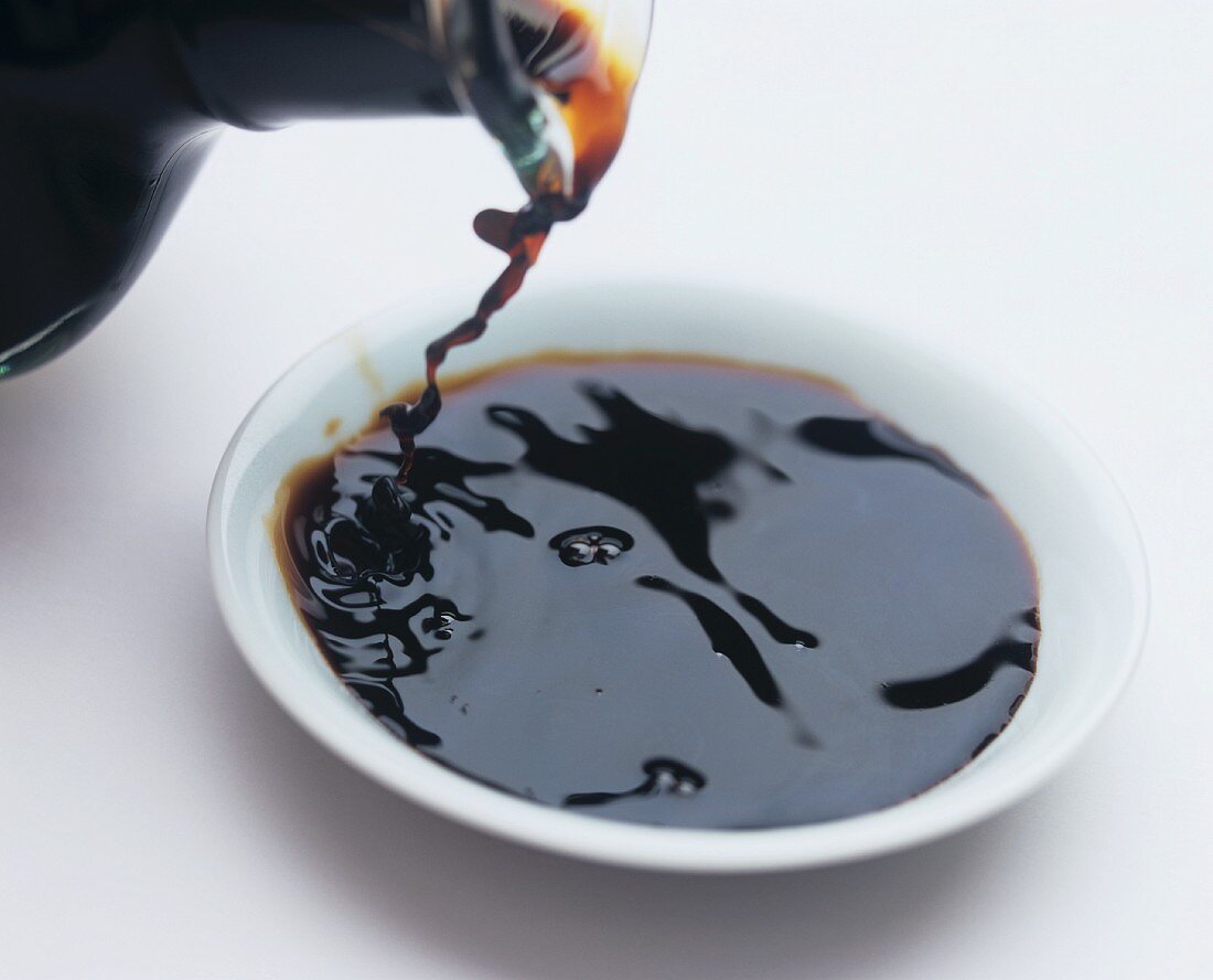Pouring balsamic vinegar into a bowl