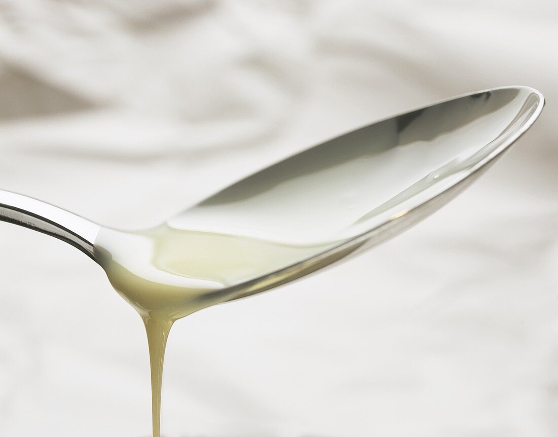 Condensed milk running from a spoon