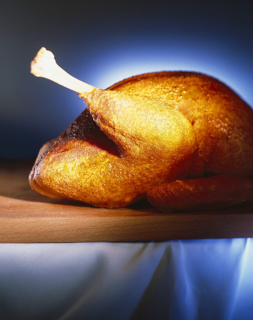 Whole roast turkey on a wooden board
